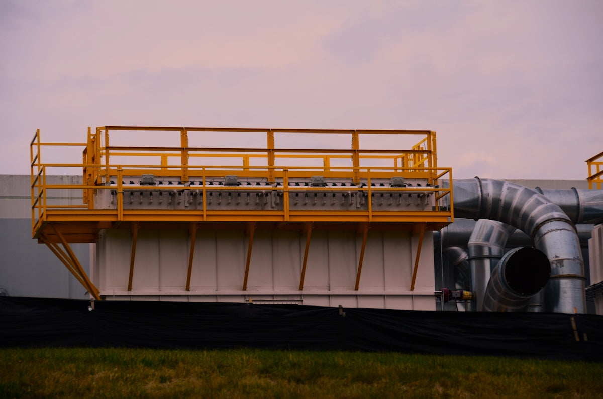 a large metal pipe next to a building