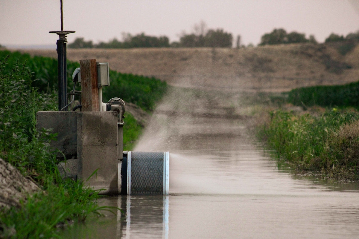 A truck driving down a flooded road