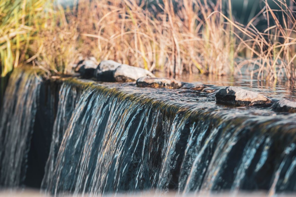 the water is flowing over the rocks in the stream